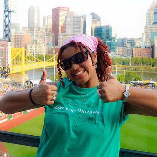 A student poses in front of the field at PNC park.