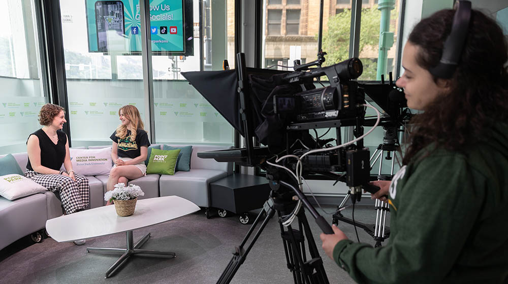 Students on set in the Center for Media Innovation TV studio.