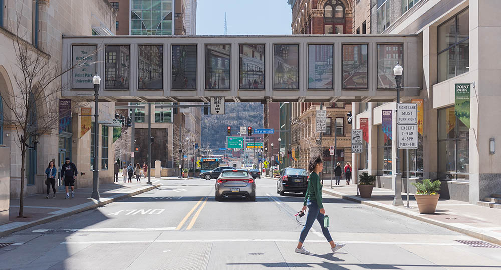 A student crosses Wood Street on Point Park's campus. Photo | Nick Koehler