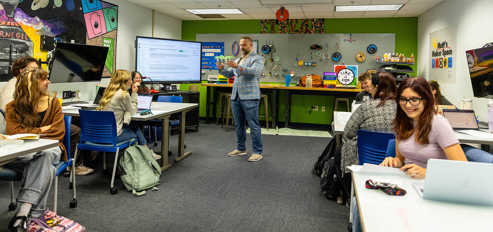 A professor teaches a School of Education class in Matt's Maker Space.
