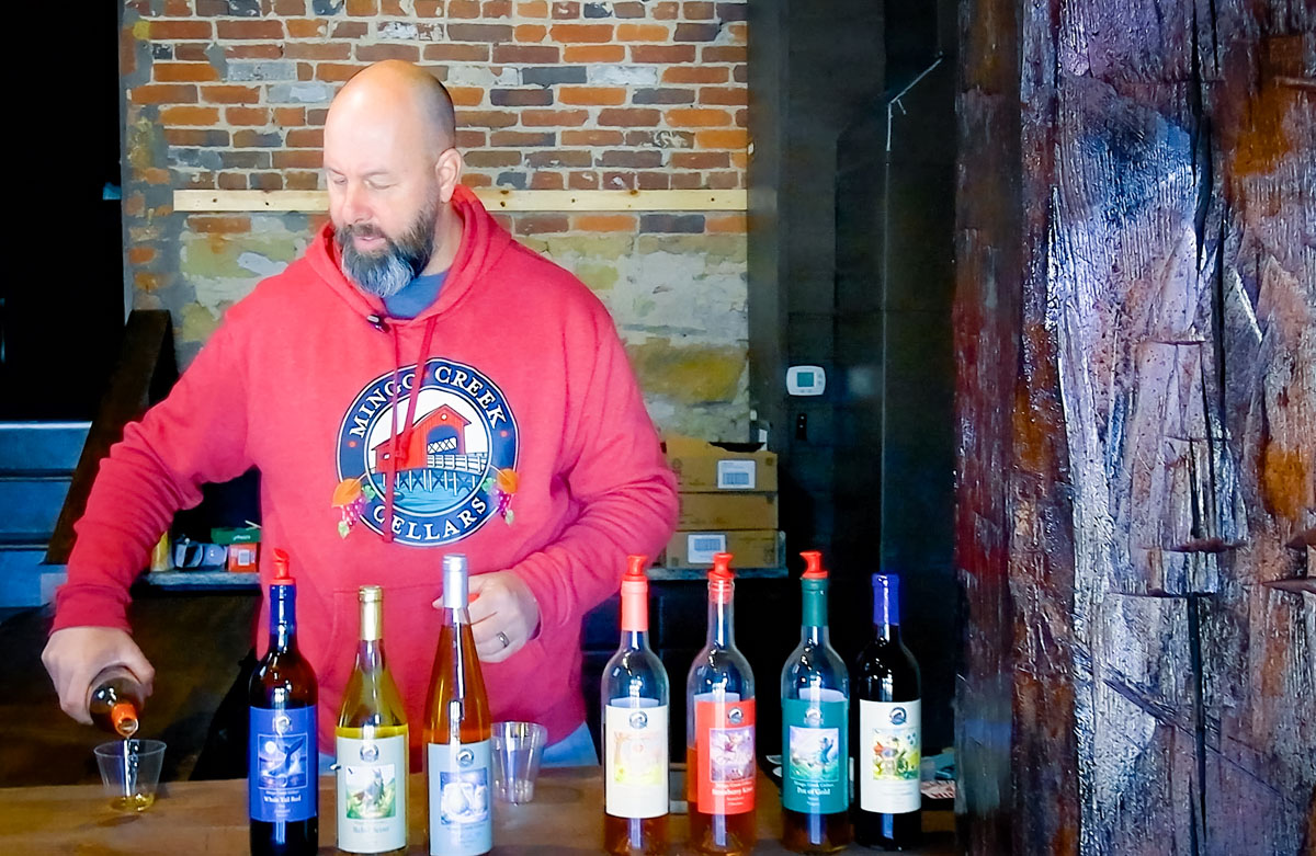 Jeff Seaman pours a tasting of wine. 