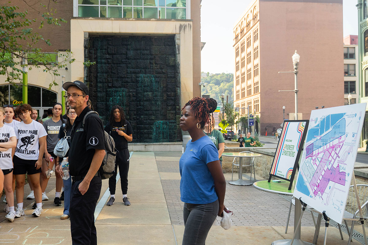 Local partners work with students for a downtown clean up project.