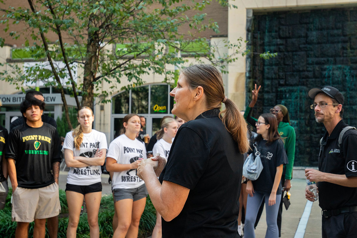 Heather Starr Fiedler talks to students before a downtown cleanup.