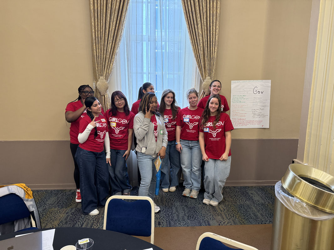 A group of girls wearing red t-shirts that read Girl Gov.