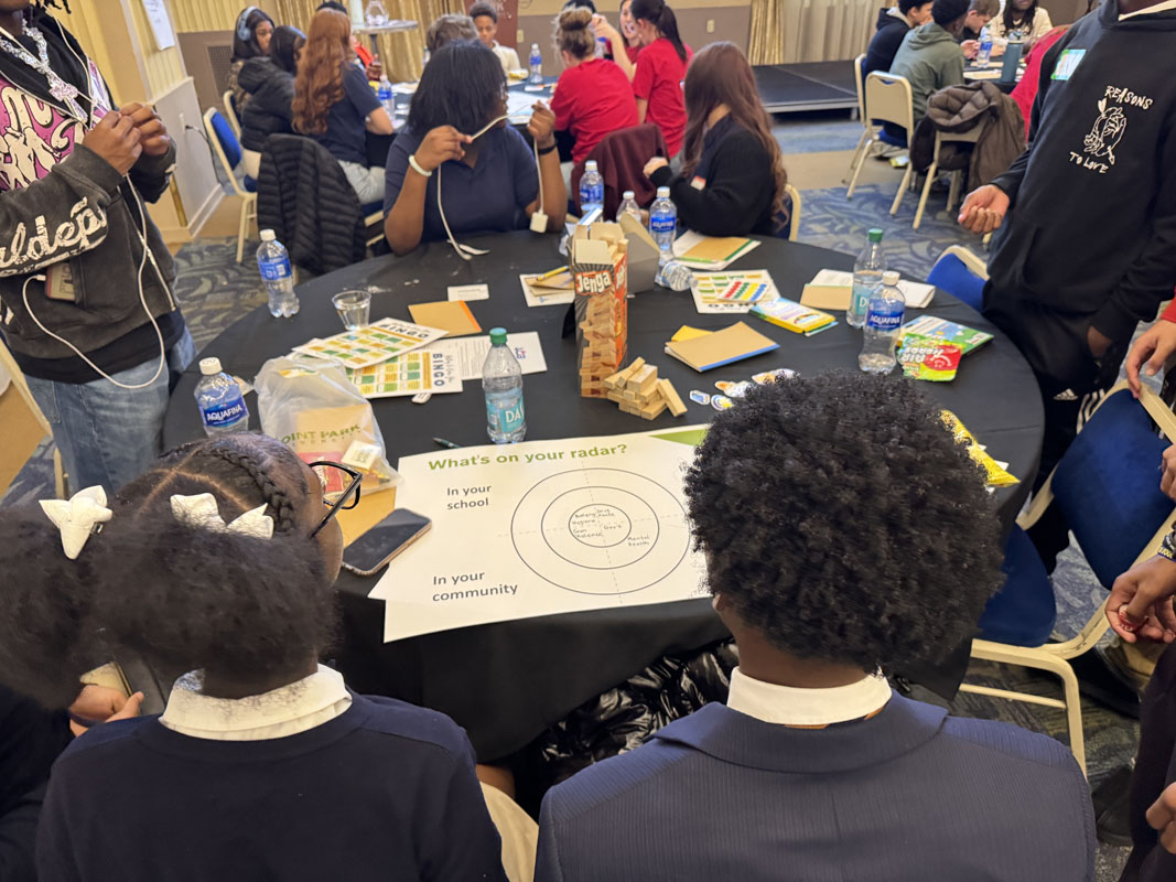 High School students fill out a chart. 