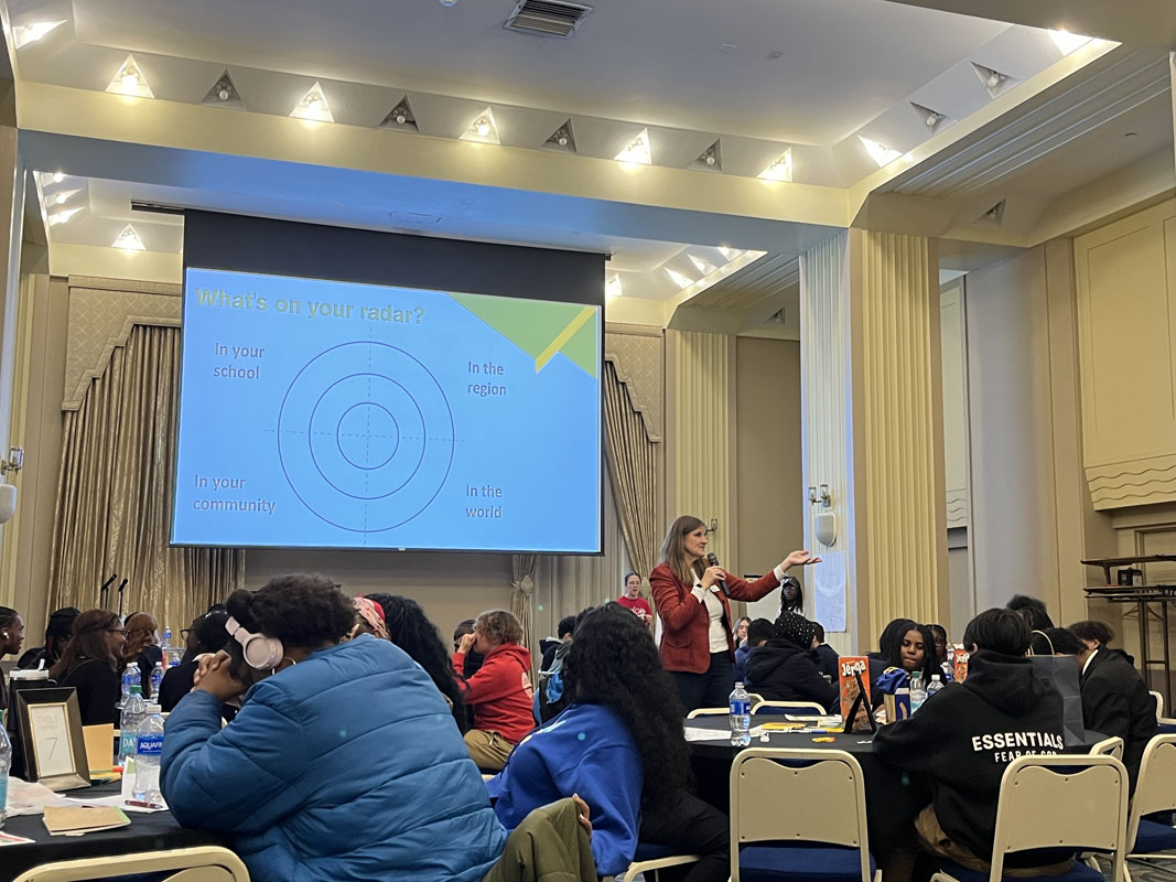 Heather Starr Fiedler addresses the ballroom full of middle and high school students. 