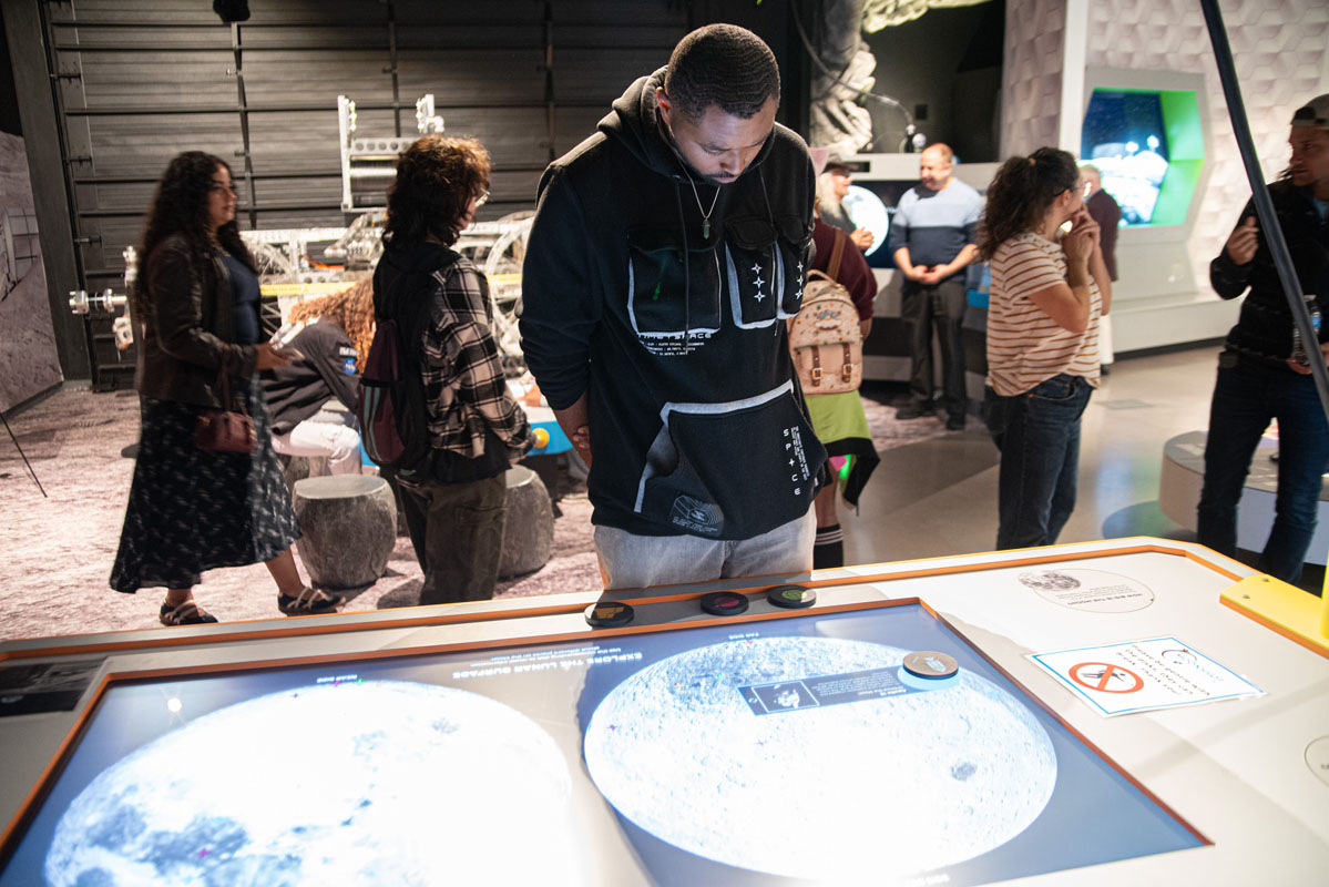 Students look at a display at the Moonshot Museum. 