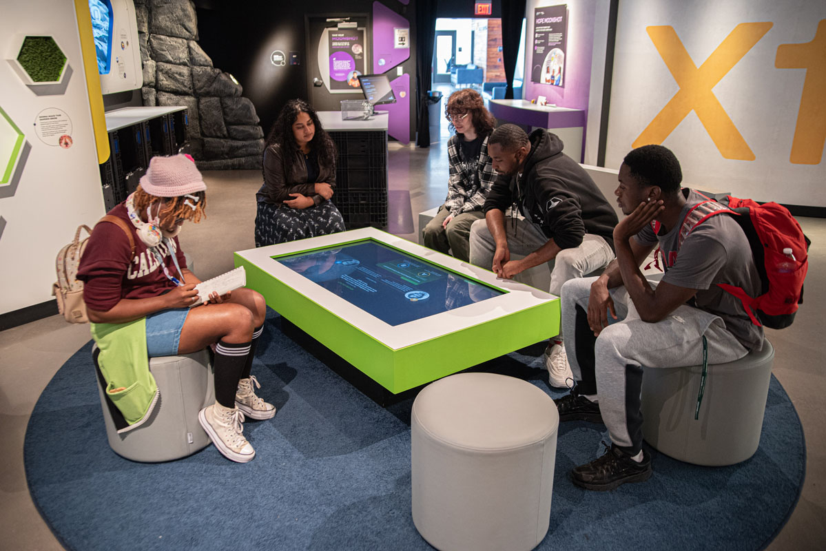 Students look at a display at the Moonshot Museum. 
