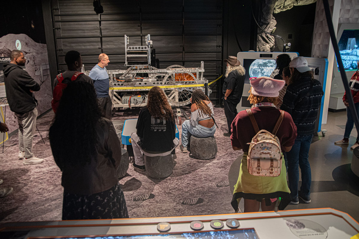 Students look at a display at the Moonshot Museum. 