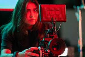 Pictured is a student with a Red Camera. 