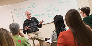 Pictured is Bob O'Gara teaching an advertising and public relations class. Photo | John McKeith