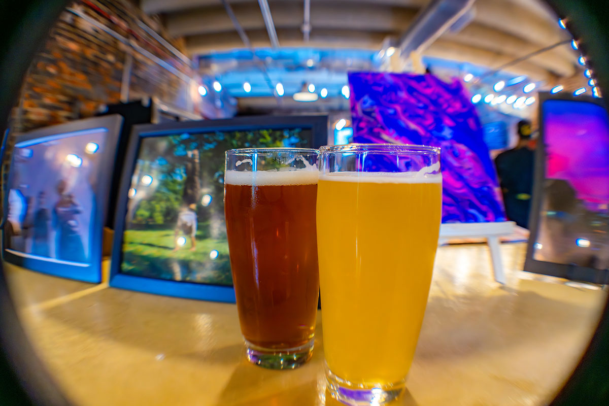 Two glasses of beer, one light and one dark.