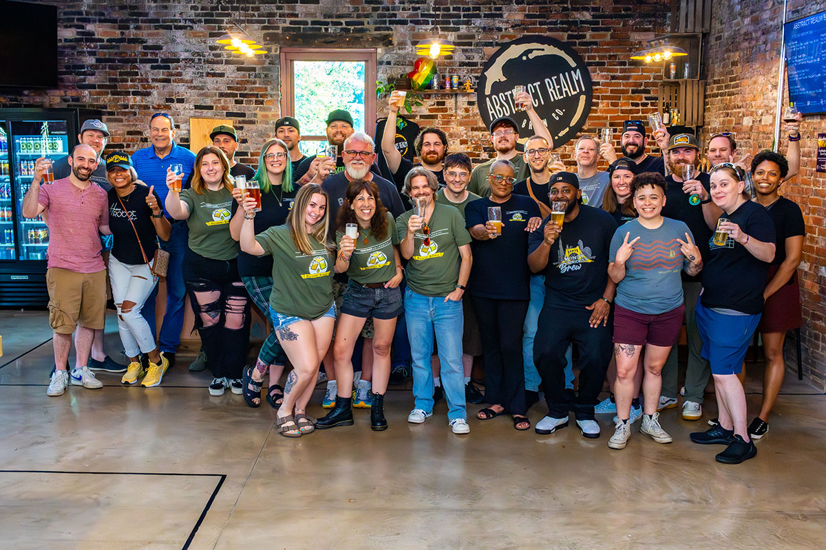 A group of graduates and alumni of the brewing class pose for a photo.