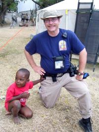 Robert Skertick, assistant professor of public administration, with a Haitian boy during medical mission following the Jan. 12 earthquake. | Photo courtesy of Robert Skertich