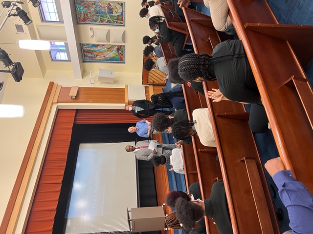 Dr. Mitchel Nickols and Dean Stephen Tanzilli speak to students at The Neighborhood Academy. Submitted photo.