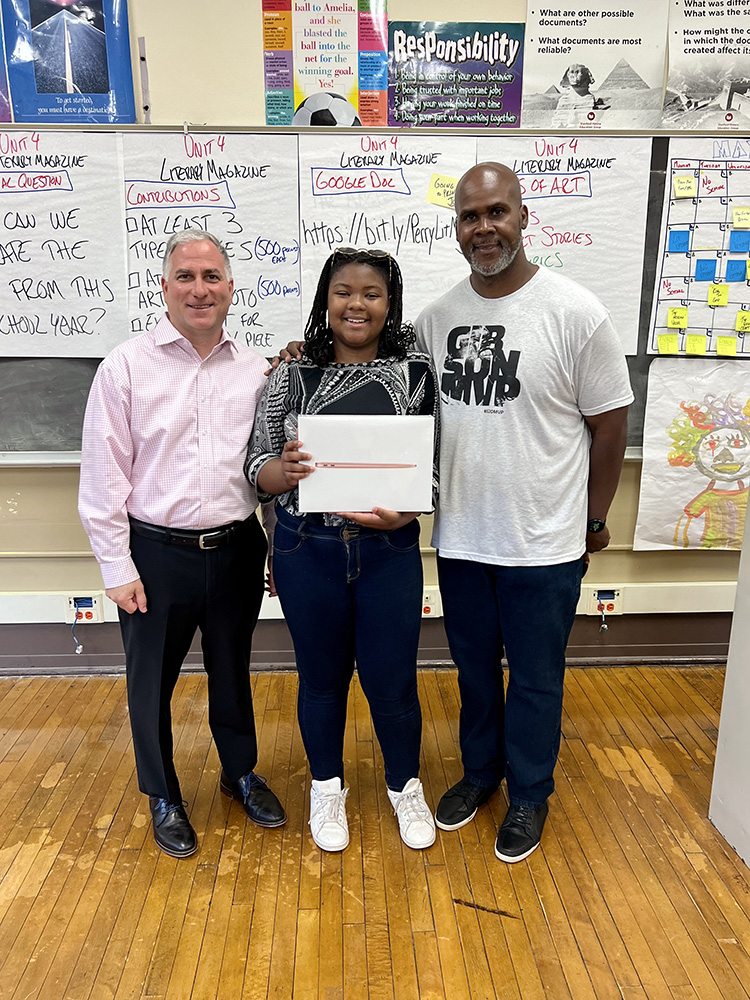 The Chuck Cooper and Josh Gibson Center for Equity and Education presented its first Student Achievement Award on June 9, 2022 at Perry Traditional Academy. Onya Goodwin, a sophomore, received an MacBook Pro Air laptop for her outstanding achievements in Cooper Gibson programs. Pictured are Dean Stephen Tanzilli, Onya Goodwin and Sean Gibson, president of Josh Gibson Enterprise and the executive director of the Josh Gibson Foundation.