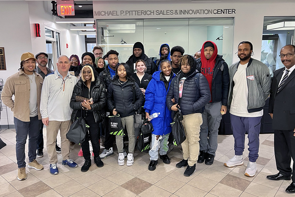 Pictured are students from Perry High School, Steve Tanzilli, dean of the Rowland School of Business, Mitchel Nickols, Ph.D., director of Rising Brothers and Sisters, and Point Park students and faculty in the Michael P. Pitterich Sales & Innovation Center. Submitted photo.