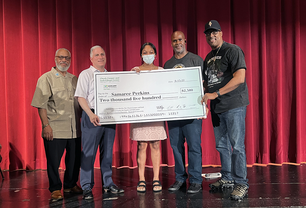 Pictured from left to right are Melvin Hubbard El, community advisor with the Office of the Mayor; Stephen Tanzilli, dean of the Rowland School of Business; Samaree Perkins, Obama Academy senior and scholarship recipient; and Sean Gibson and Chuck Cooper III, co-founders of the Chuck Cooper and Josh Gibson Center for Equity and Education.