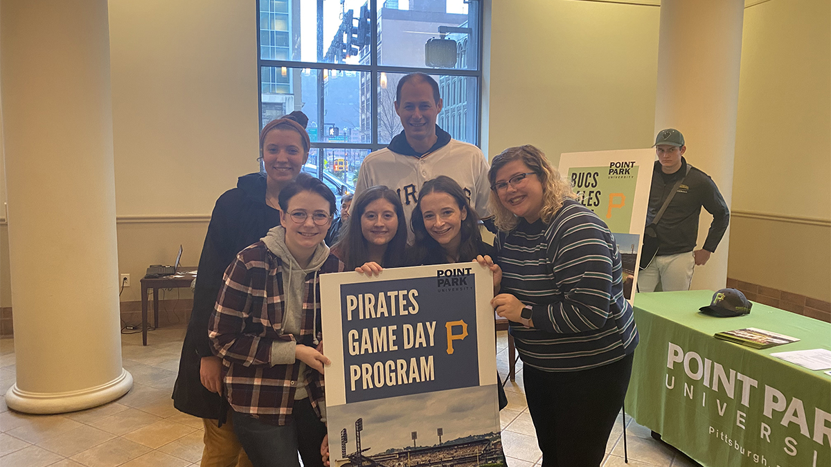 At the Pirates Care-A-Van event at Point Park, students in the Pittsburgh Pirates internship program are pictured with Point Park alumnus and Pirates Bench Coach Don Kelly.