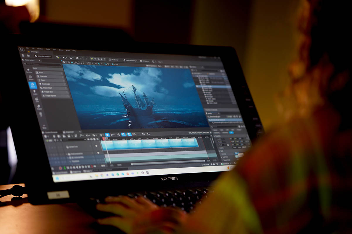 A student uses Adobe Premiere to edit "Bones in the Ocean."