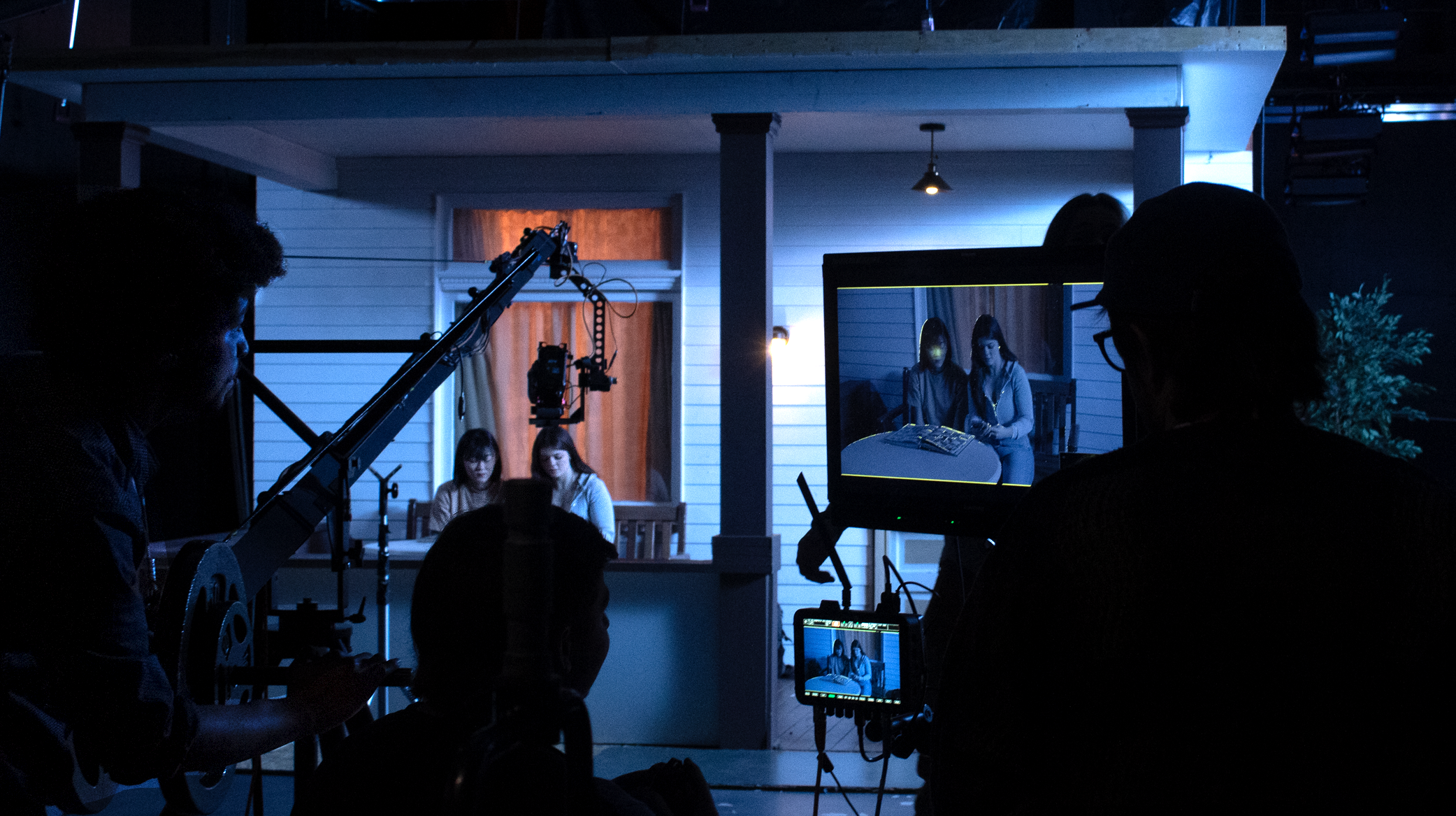 Students on set of a film shoot in the soundstage on campus.
