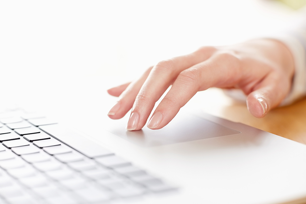 Pictured is a hand typing on a laptop. File photo.