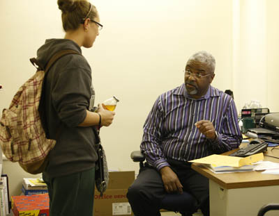 Pictured is education professor Dr. Stanley Denton talking with a student.