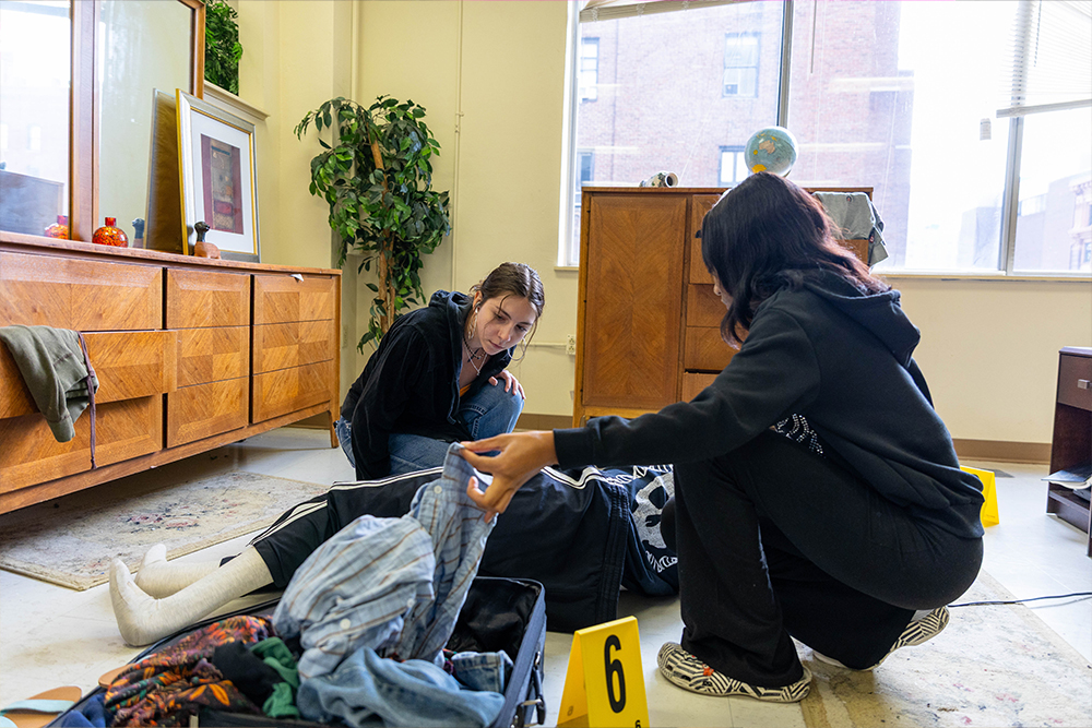 Pictured are two students conducting a mock investigation in the CSI House. Photo by Randall Coleman.
