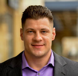 Pictured is Daniel Mikulan, a veteran, 2013 intelligence and national security alumnus of Point Park and a cyber intrusion analyst for PNC. | Photo by Jim Judkis