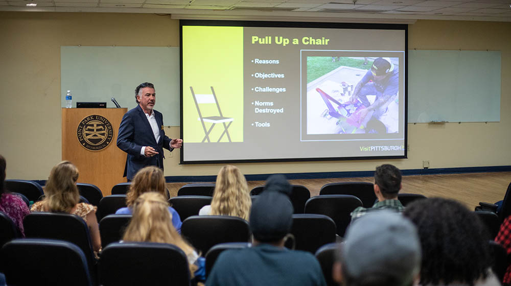 Tom Loftus, chief marketing officer, VisitPITTSBURGH speaks to students in JVH Auditorium. Photo | Hannah Johnston