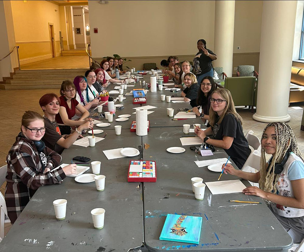 Pictured are Honors Program students participating in a painting project in the Lawrence Hall lobby.