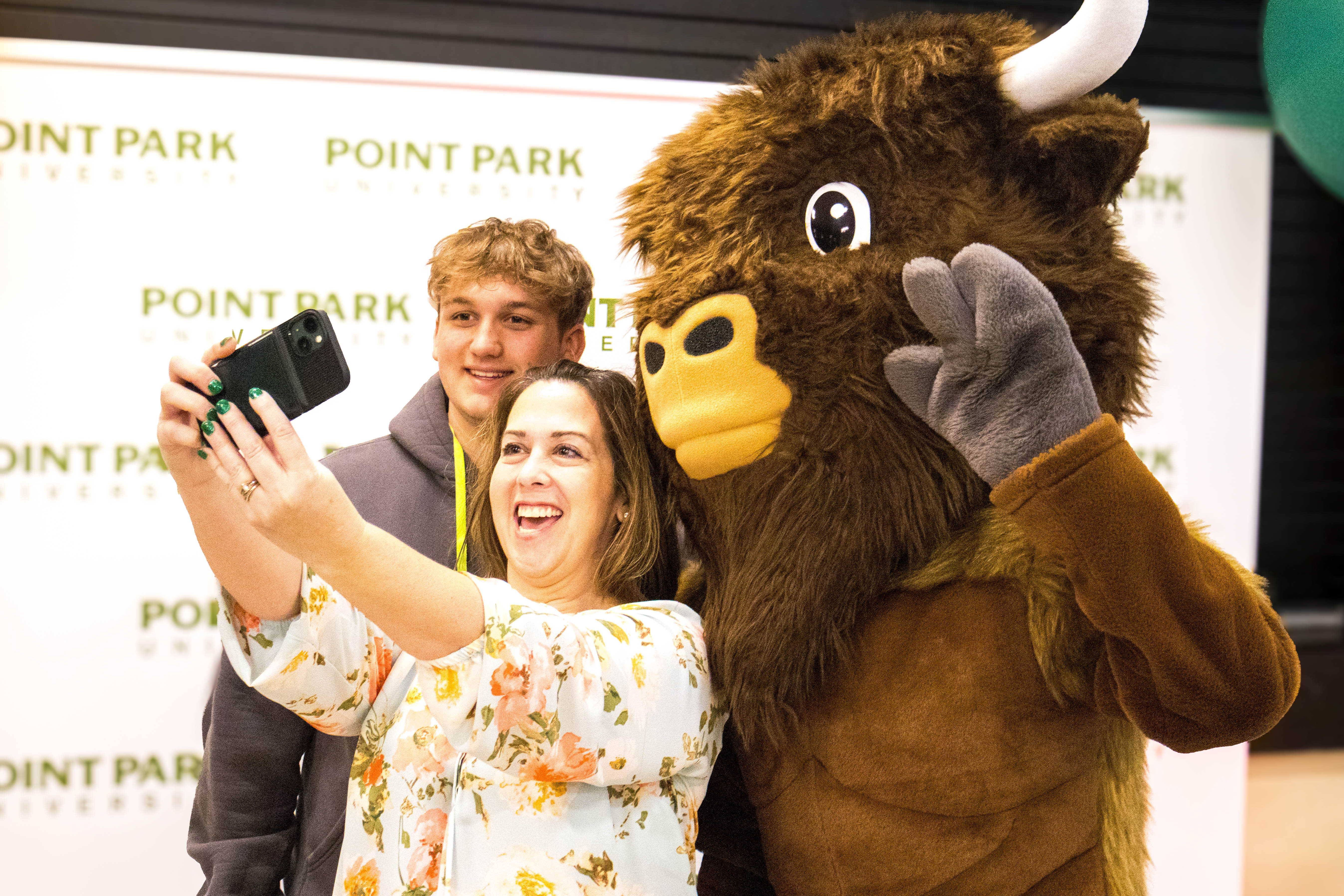 Pictured is a prospective student with their parent, posing with the Point Park Mascot Black Diamond.. Photo by Chloe Humway.