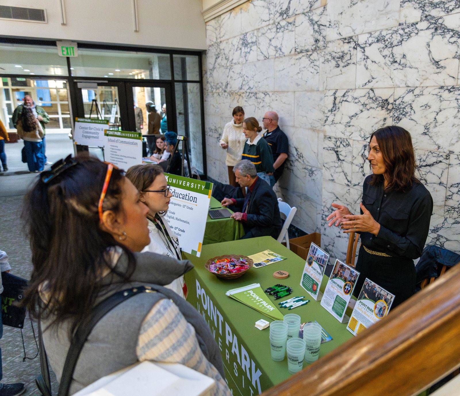 Pictured Professor Kamryn York from the School of Education talking to prospective students at Open House. Photo by Paul Koontz.