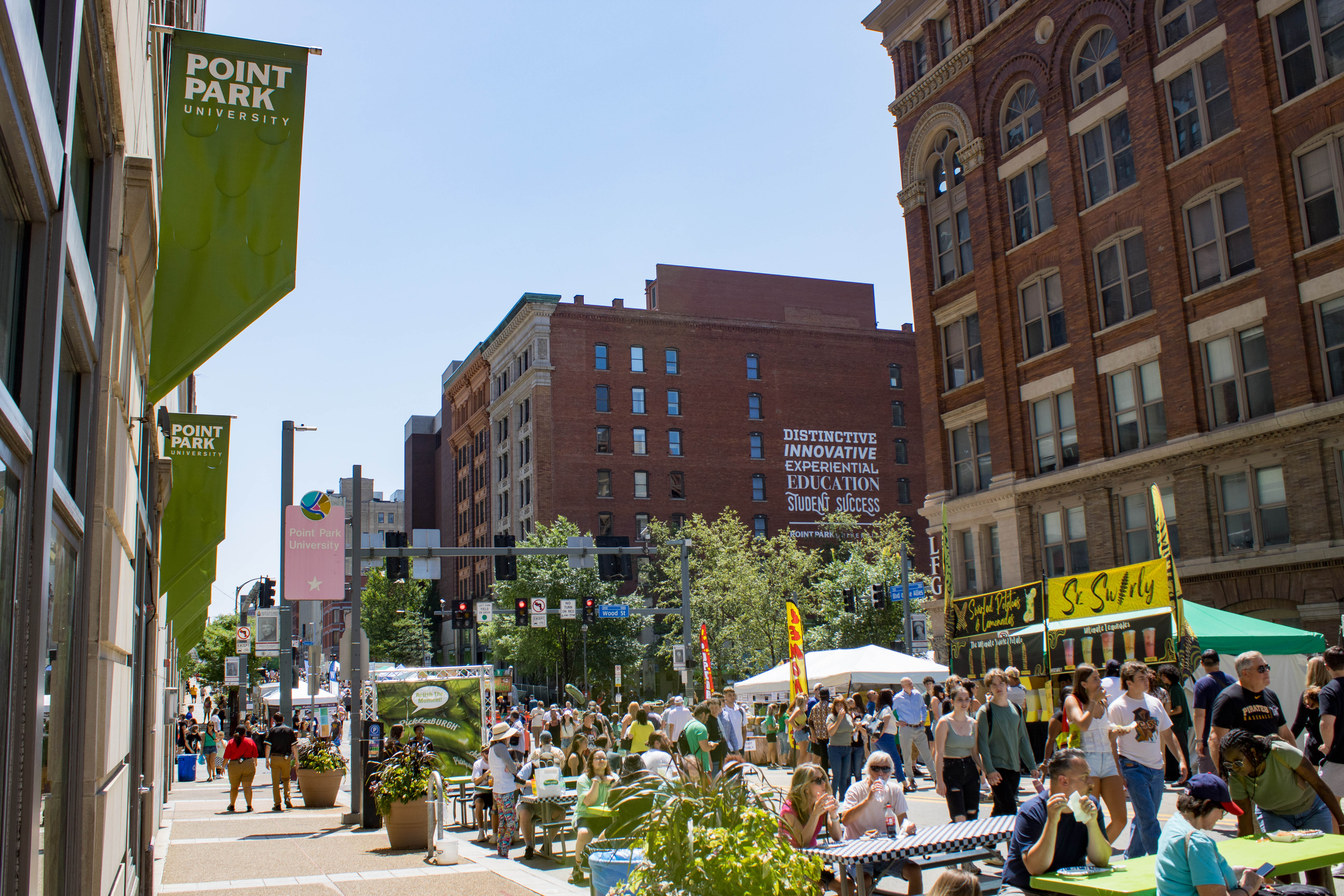 Campus during Picklesburgh festival with people eating and walking