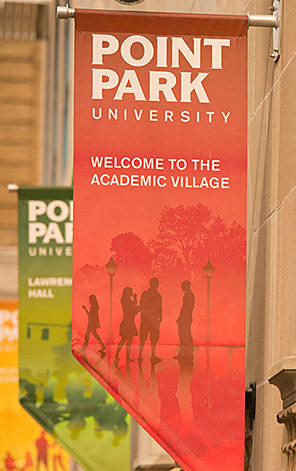 A red banner displaying the Point Park logo welcomes visitors to the Academic Village.