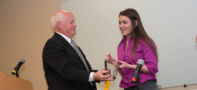 Pictured is Visiting Associate Professor of Criminal Justice Richard Linzer, J.D., with a new Point Park student inductee of the Alpha Phi Sigma honor society. | Photo by Chris Rolinson