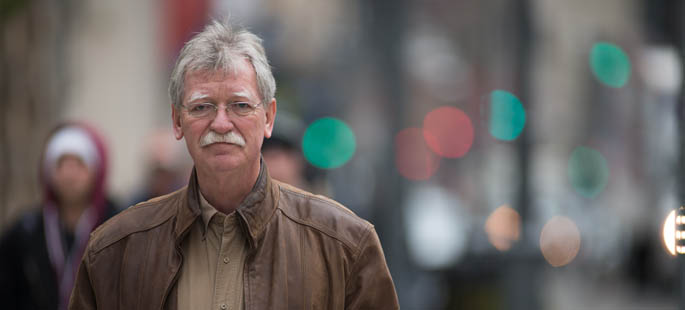 Pictured is Andrew Richards, instructor of criminal justice and intelligence studies, in Downtown Pittsburgh. | Photo by Chris Rolinson