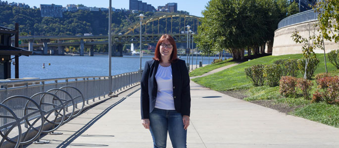Pictured is Courtney Mahronich, political science and M.S. environmental studies alumna who is now director of trail development for Friends of the Riverfront. | Photo by Olivia Ruk