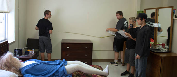 Pictured are high school students in the crime scene house at Point Park University. | Photo by Shayna Mendez