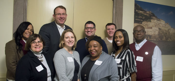 Pictured is Professor of Education Vincenne Revilla-Beltran, Ph.D., with Ed.D. students at the World Affairs Council discussion at Point Park on Dec. 6, 2016. | Photo by Shayna Mendez