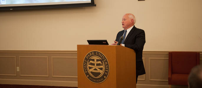 Pictured is Richard Linzer, J.D., associate professor and director of the criminal justice administration graduate program, lectures to students in Lawrence Hall. | Photo by Chris Rolinson