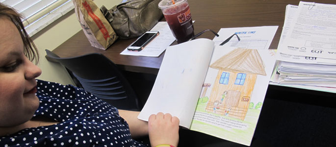 Point Park student Tracie Cardone judges an elementary student's essay. | Photo by Amanda Dabbs