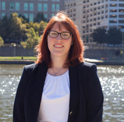 Pictured is Courtney Mahronich, political science and M.S. in environmental studies alumna and director of development for Friends of the Riverfront. | Photo by Olivia Ruk