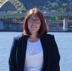 Pictured is Courtney Mahronich, political science and M.S. in environmental studies alumna and director of development for Friends of the Riverfront. | Photo by Olivia Ruk