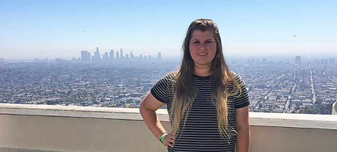 Pictured is SAEM student Cassandra Crisp in front of the Los Angeles skyline. | Photo by Angela Thomas