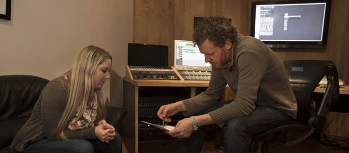 Pictured is Point Park SAEM student and musician Hannah Jenkins with Jesse Naus, owner and head engineer of Red Caiman Studios in Pittsburgh.