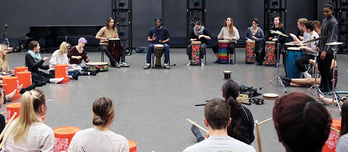 Students attend an African Drumming Class during World Cultures Dance Week. Photo | Ryan Loew