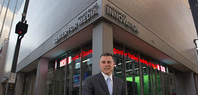 Andrew Conte sits outside of Point Park University's new Center for Media Innovation. Photo | Christopher Rolinson