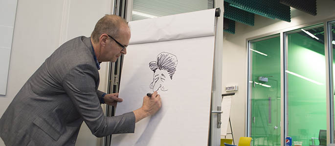 Rob Rogers from the Pittsburgh Post-Gazette sketches a political cartoon at the Center for Media Innovation. Photo | Shayna Mendez