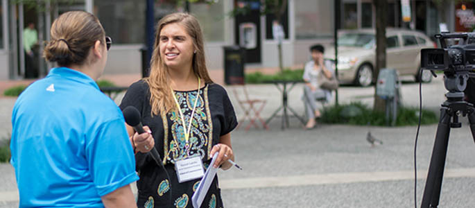 High school student Hannah Lapinski conducts an interview in Market Square. Photo | Connor Mulvaney